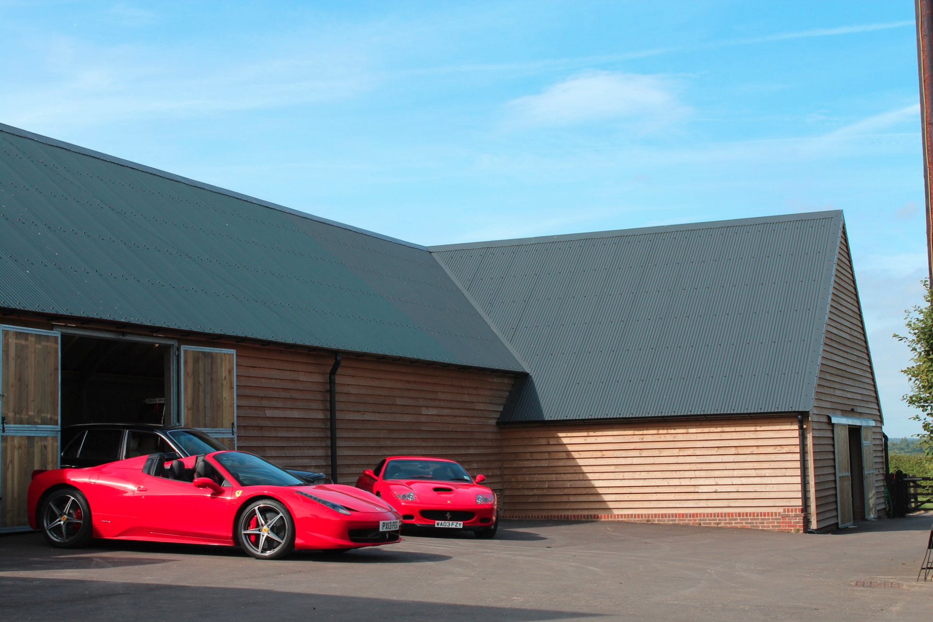 Timber clad motor house with classic cars
